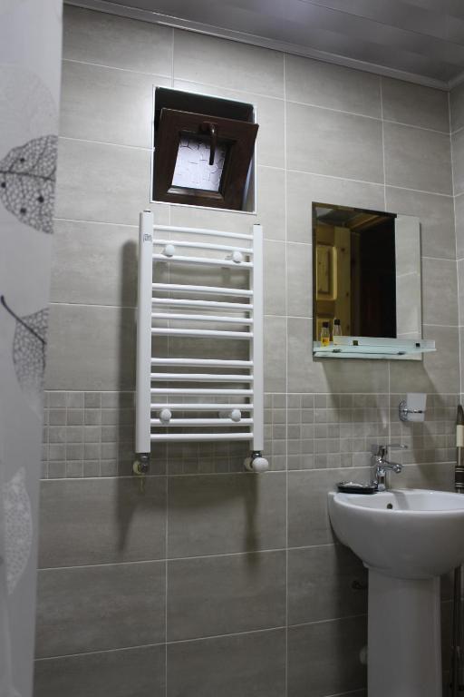 a bathroom with a sink and a mirror at Guest House on Meskheti in Borjomi