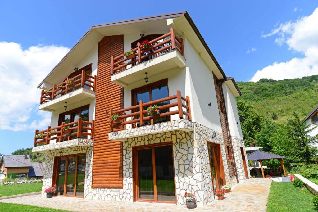 a large house with wooden balconies on top of it at Villa 'Iva' in Mavrovo