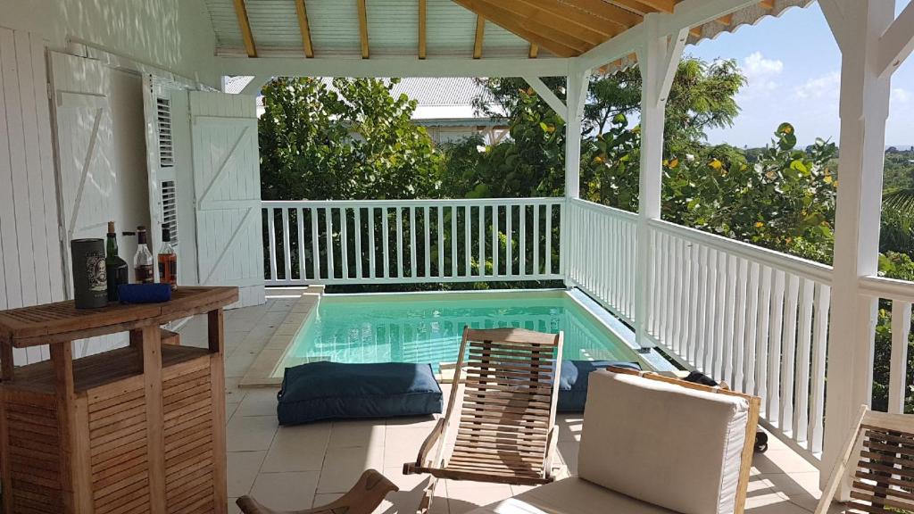 a porch with a swimming pool on a house at Villa Lauréal in Grand-Bourg