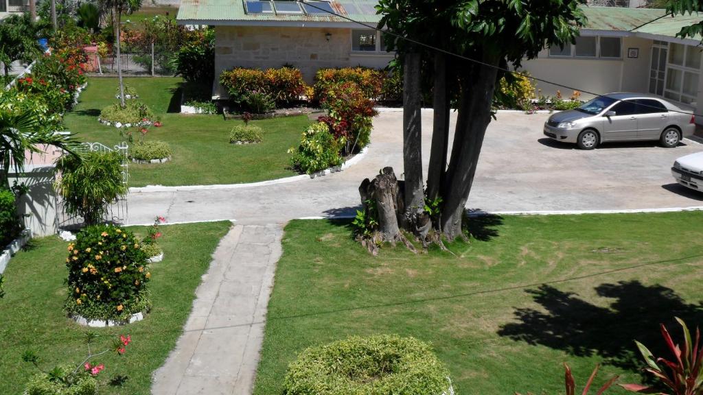 an aerial view of a park with flowers and a driveway at The Monteray Hotel in Christ Church