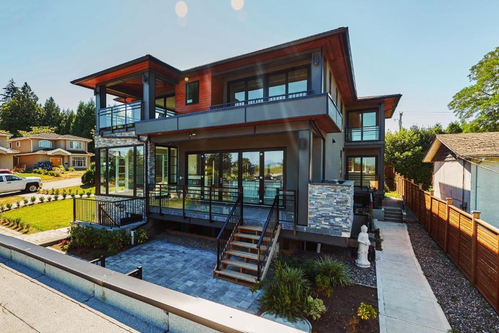 a house with a staircase leading up to it at The Chateau in Burnaby