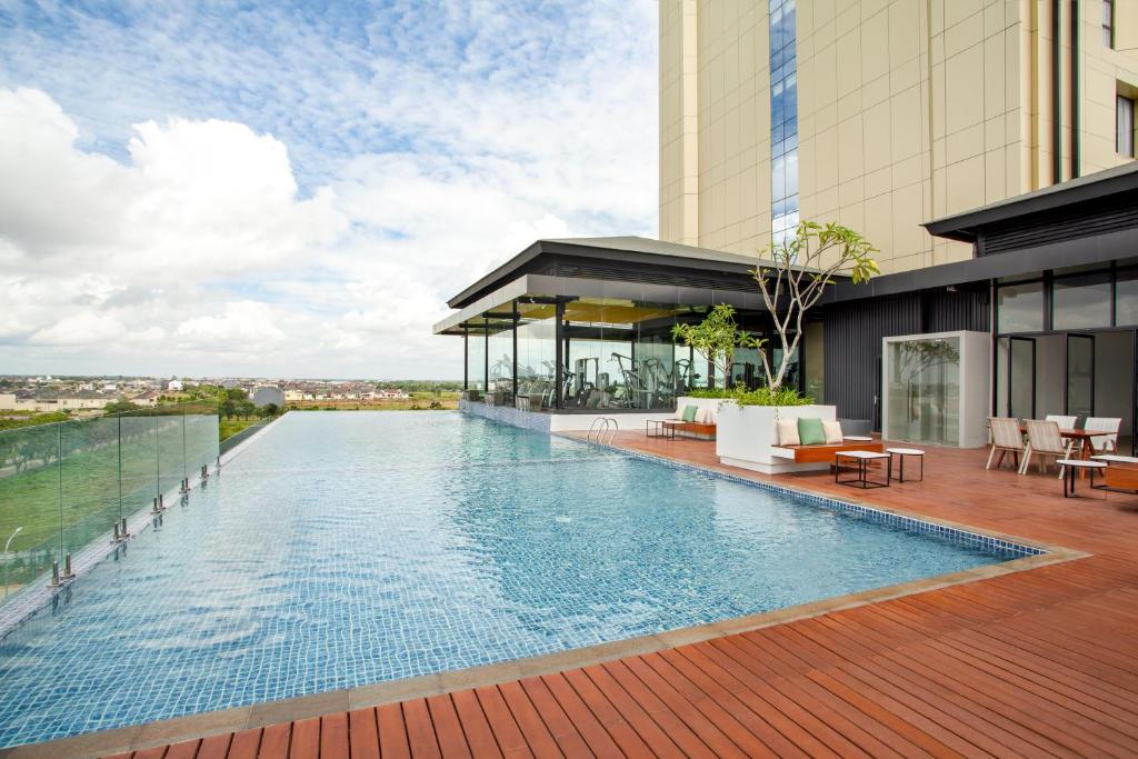 a swimming pool on the roof of a building at Wyndham Opi Hotel Palembang in Palembang