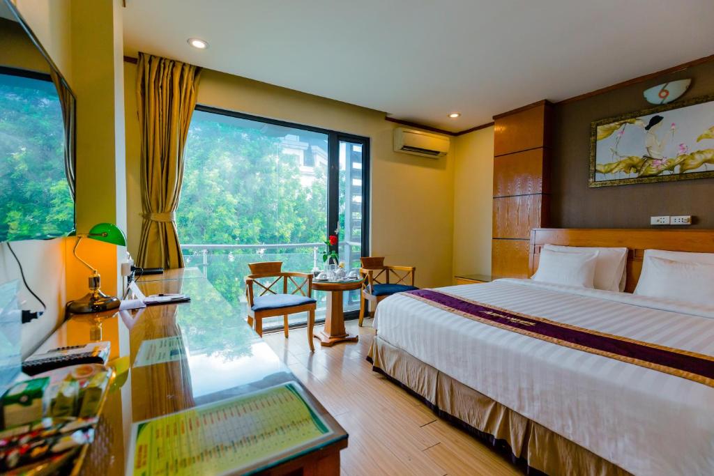 Postel nebo postele na pokoji v ubytování A25 Hotel - 45 Phan Chu Trinh