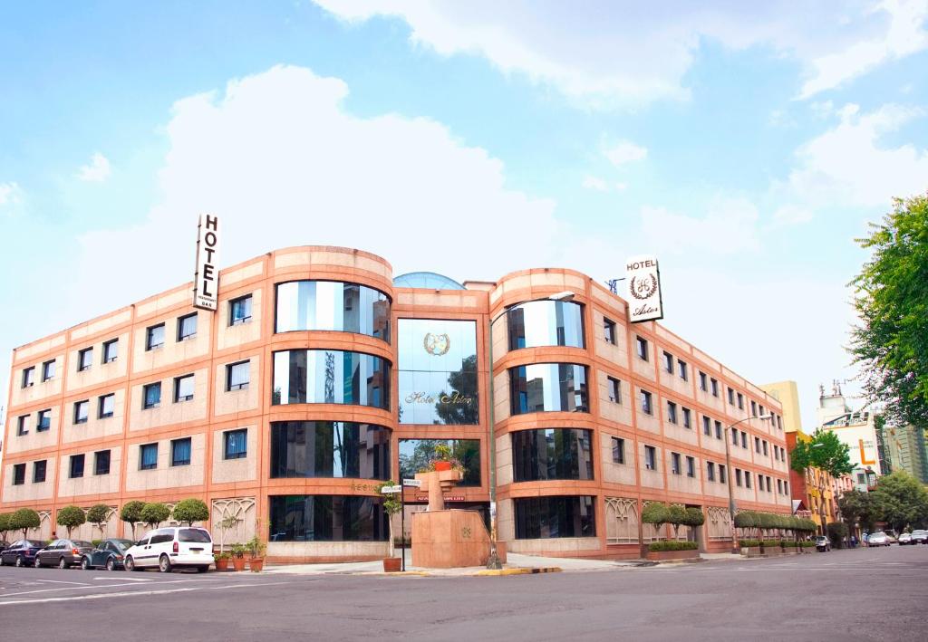 a large brick building on a city street at Hotel Astor in Mexico City