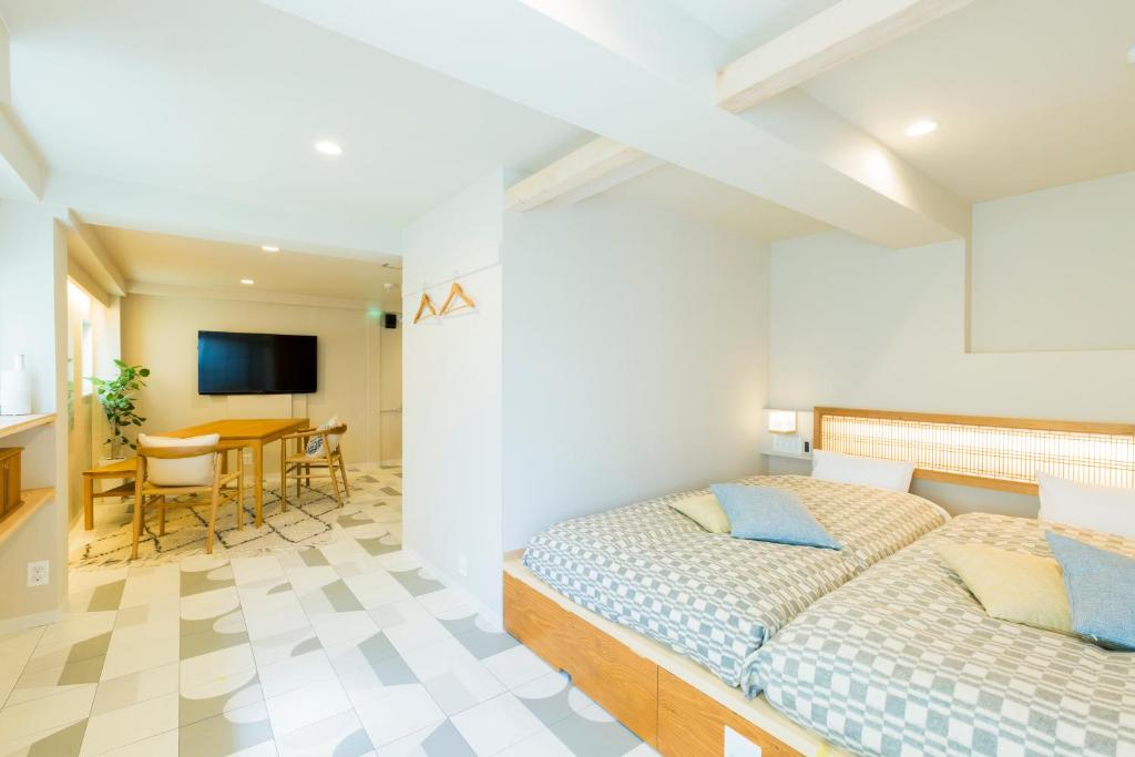 a bedroom with a bed and a dining room at KAGO 34 Tokyo by Shukuba HOTEL in Tokyo