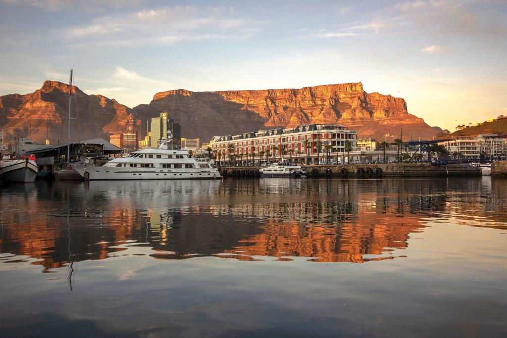 a view of a harbor with a mountain in the background at Cape Grace, A Fairmont Managed Hotel in Cape Town