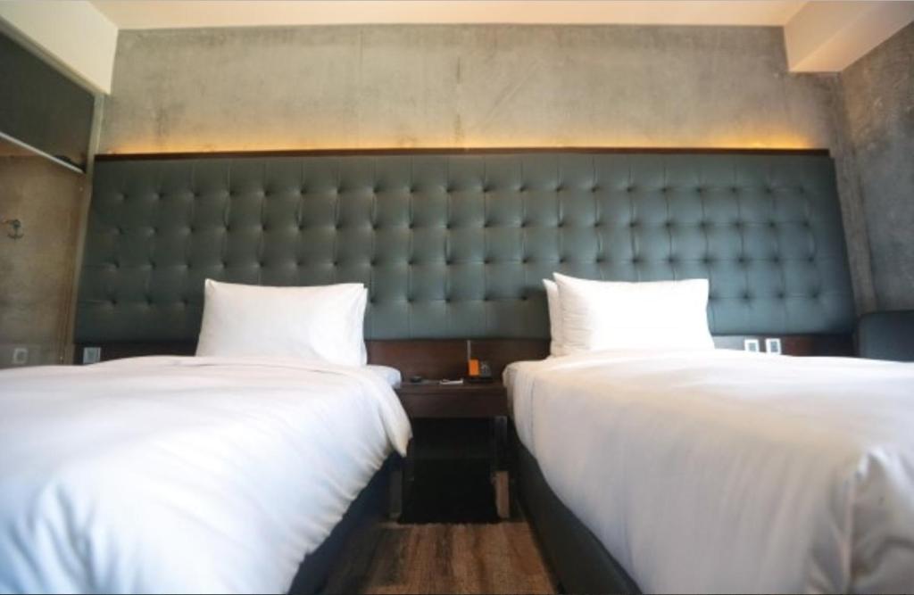 Postel nebo postele na pokoji v ubytování The B Hotel Quezon City