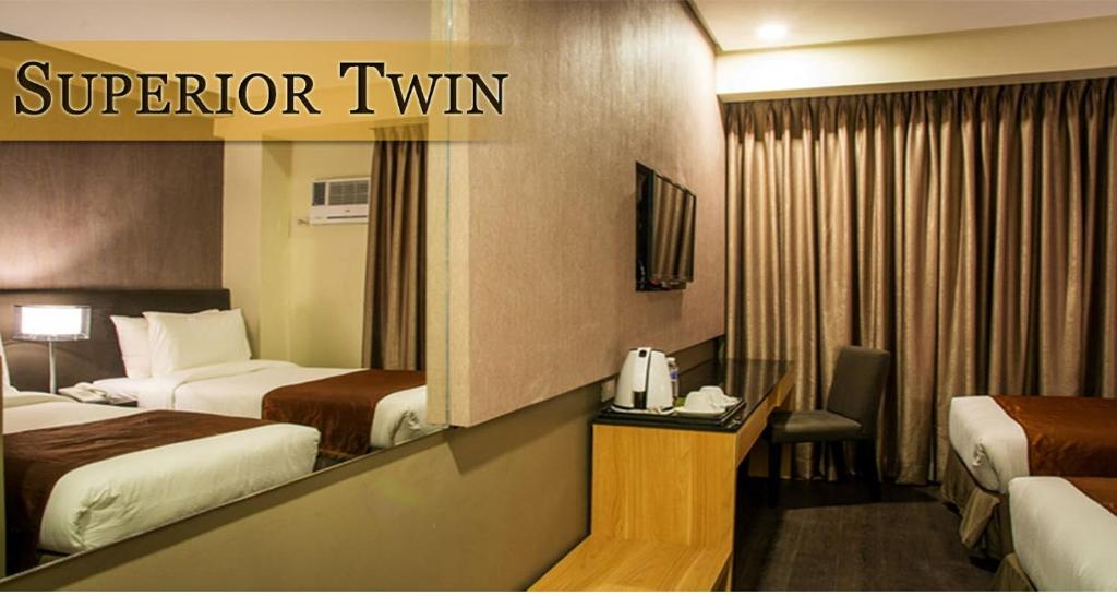 Postel nebo postele na pokoji v ubytování GT Hotel Iloilo