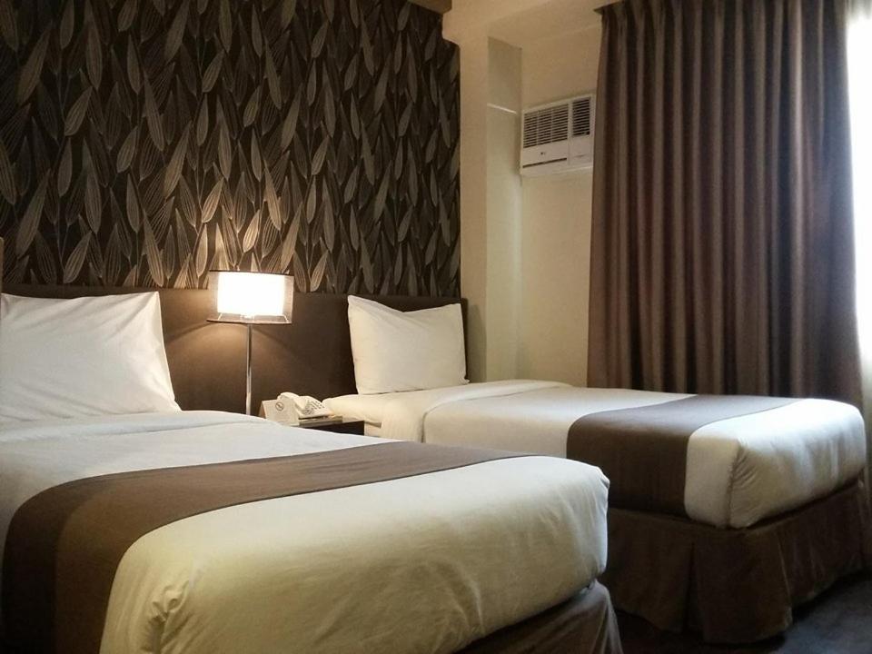 Postel nebo postele na pokoji v ubytování GT Hotel Iloilo