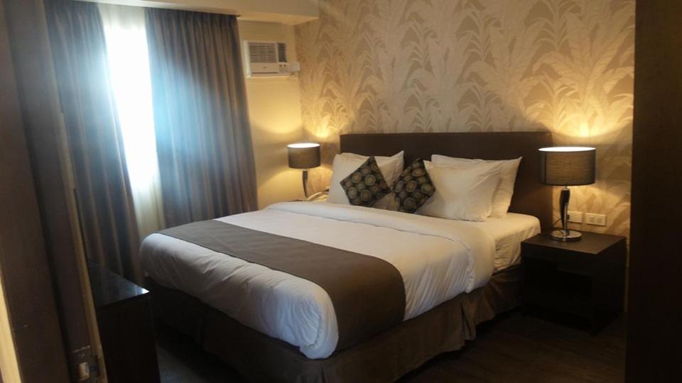 Postel nebo postele na pokoji v ubytování GT Hotel Iloilo