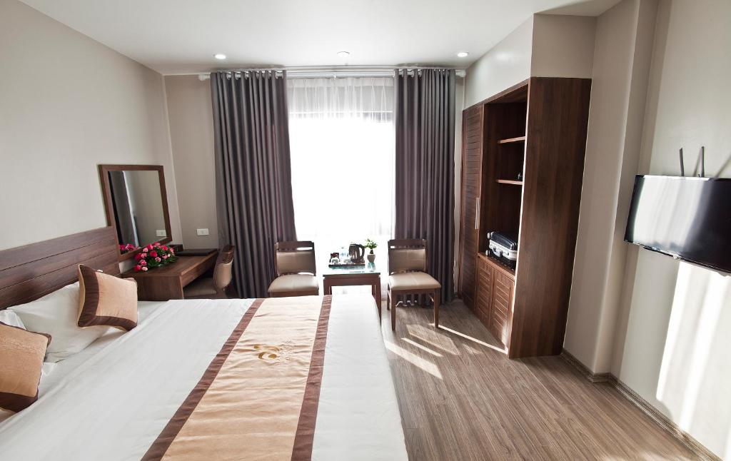Postel nebo postele na pokoji v ubytování Victor Hanoi Hotel