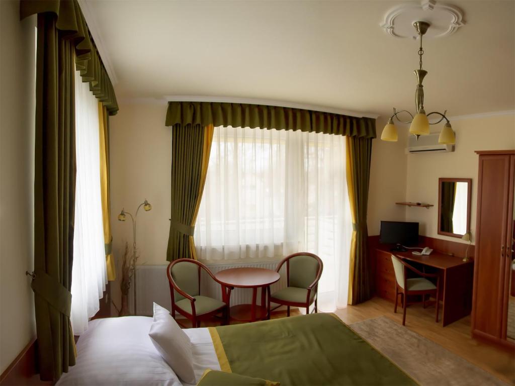 Postel nebo postele na pokoji v ubytování Apartman Bella Hotel