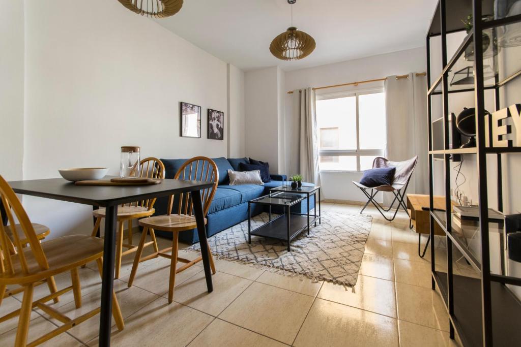 a living room with a blue couch and a table at Apartamento Good Morning Velvet in Vecindario