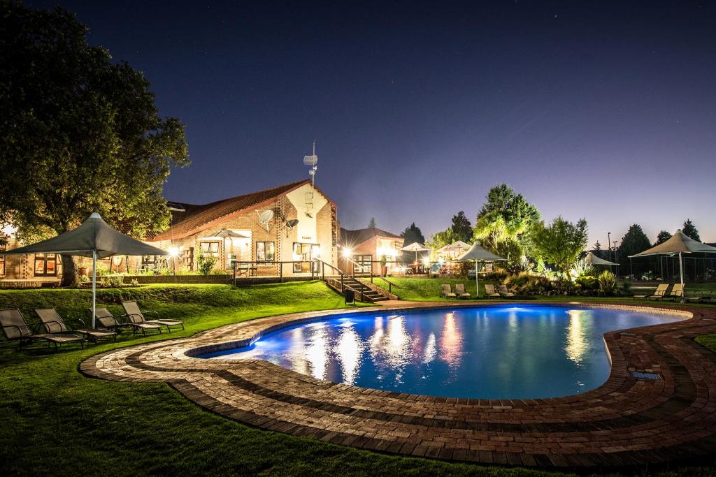 a swimming pool in the yard of a house at First Group Qwantani in Harrismith