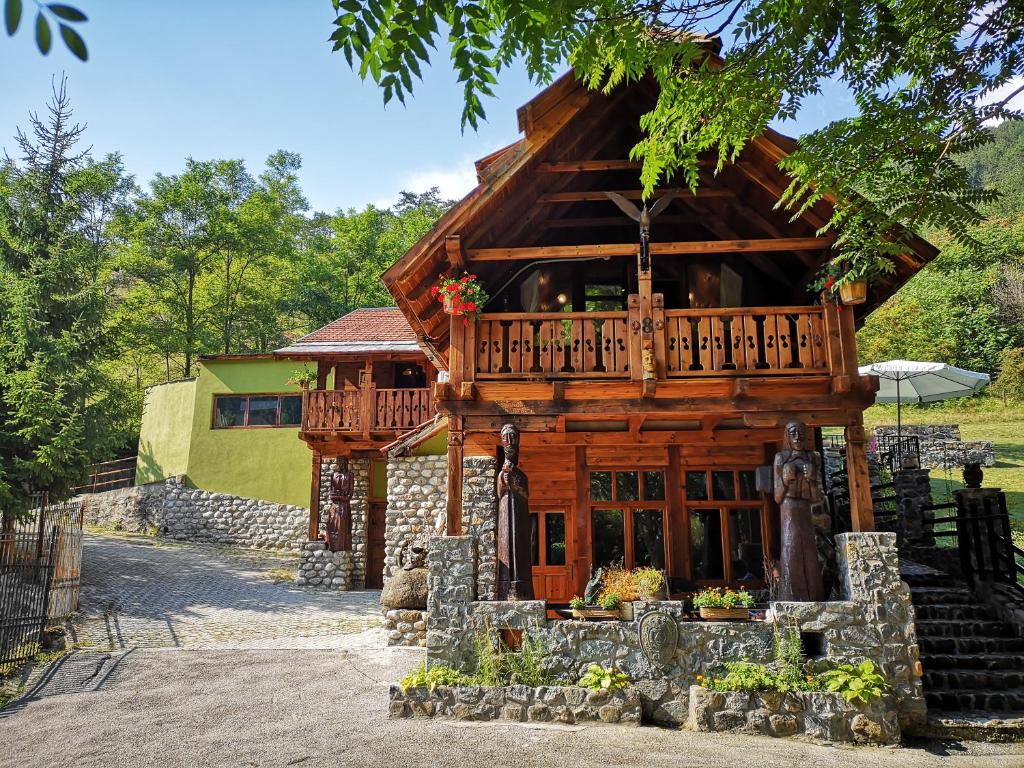 a log cabin with a balcony and a porch at Apartments DM in Mokra Gora