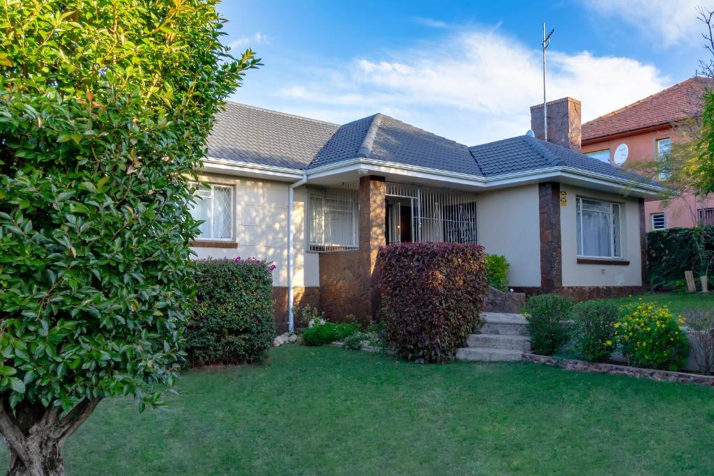 a house with a green yard at Munro Suites in Port Elizabeth