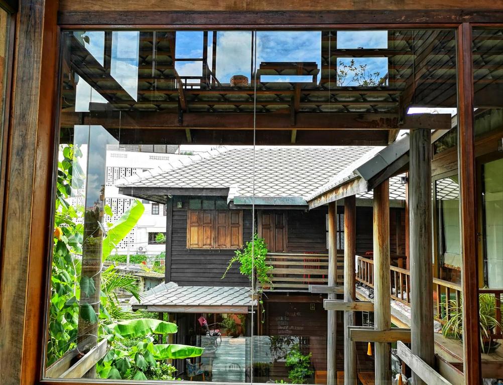 a view of a house through a window at Siamotif Boutique Hotel in Bangkok