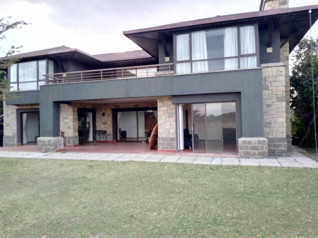 a large house with a large patio in front of it at Ol Pejeta Holiday Villas in Nanyuki