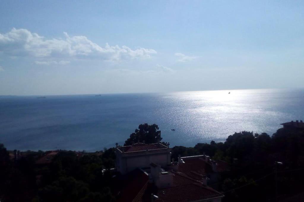 a view of the ocean with a building in the foreground at Amazing Sea view, free parking, near to the centre in Trieste