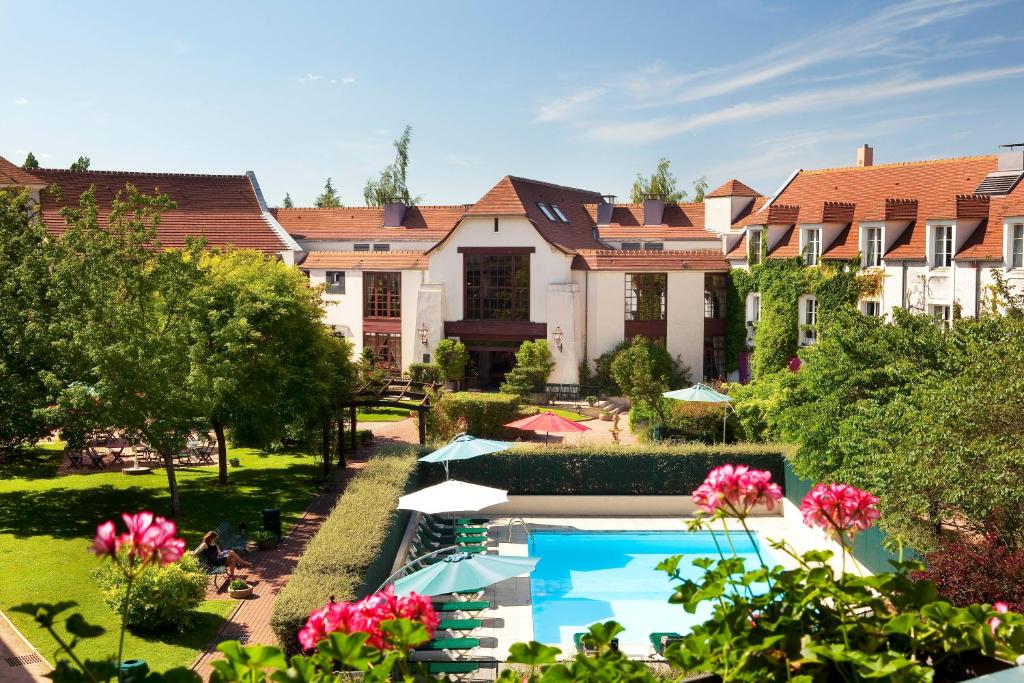 an aerial view of a resort with a swimming pool at Le Manoir de Gressy in Gressy