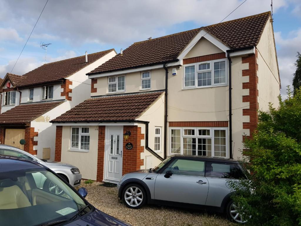 a house with a car parked in front of it at Spacious Swindon 5 bedroom house - sleeps up to 10 in Swindon