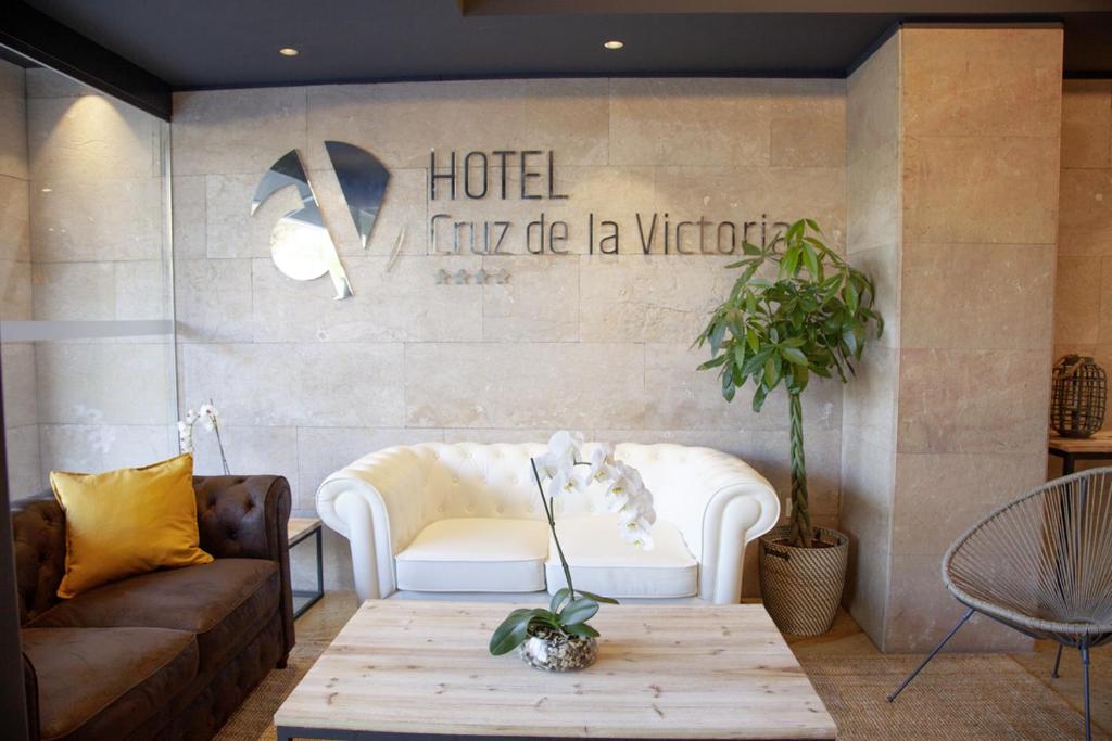 a living room with a couch and a coffee table at Hotel Cruz de la Victoria in Berrón