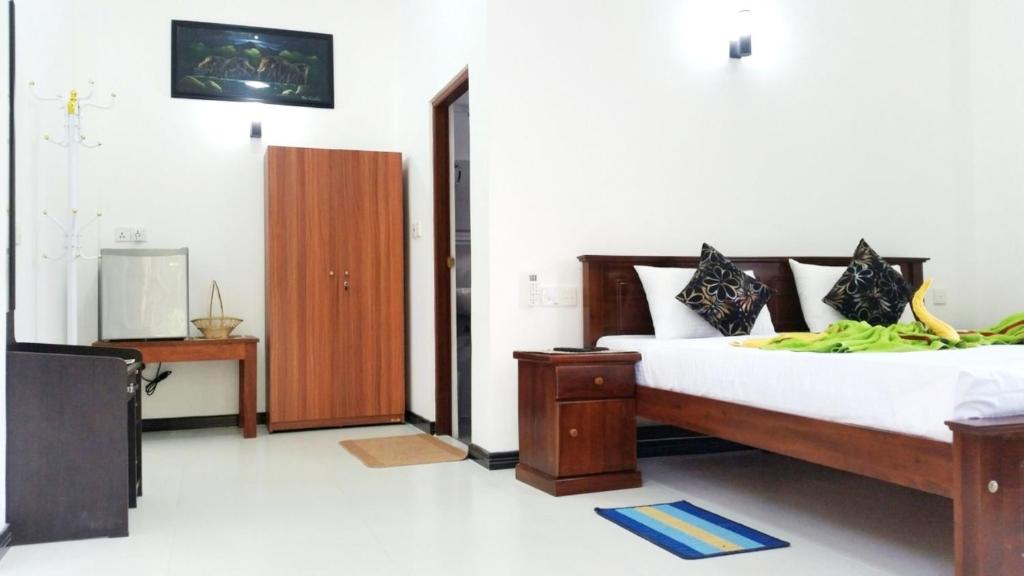 a bedroom with a bed and a tv in it at Lake Lane Guest Rest in Koggala