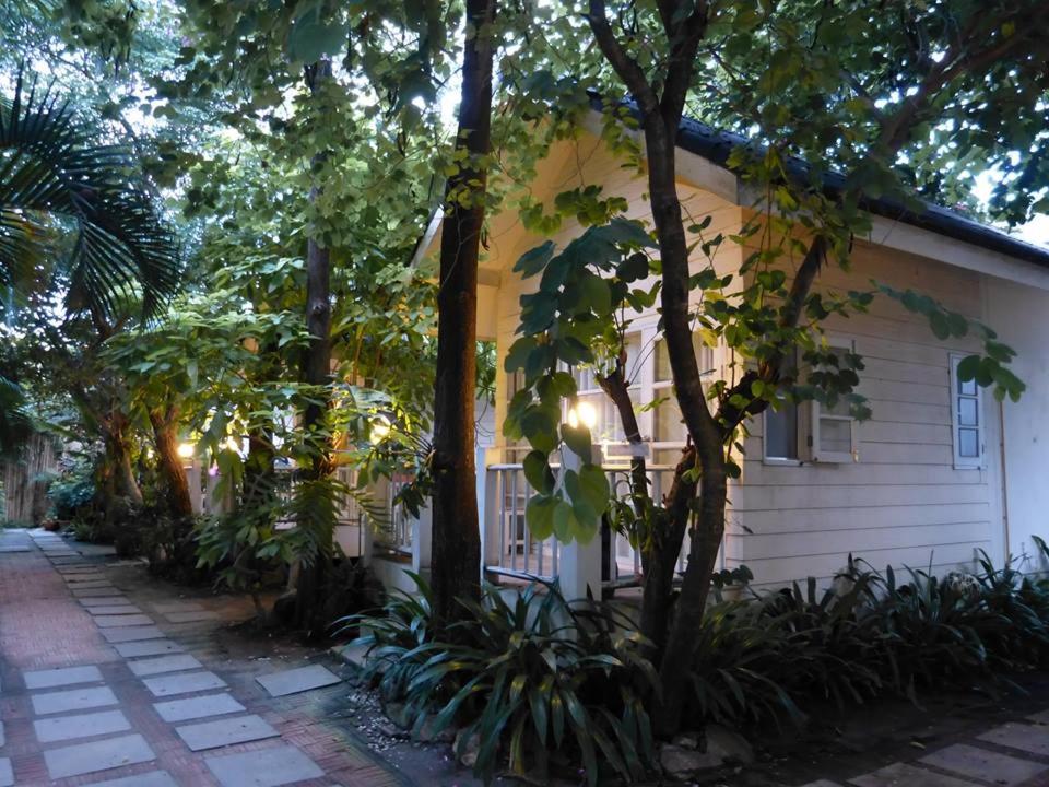 a house with trees and plants in front of it at Reera Resort in Hua Hin