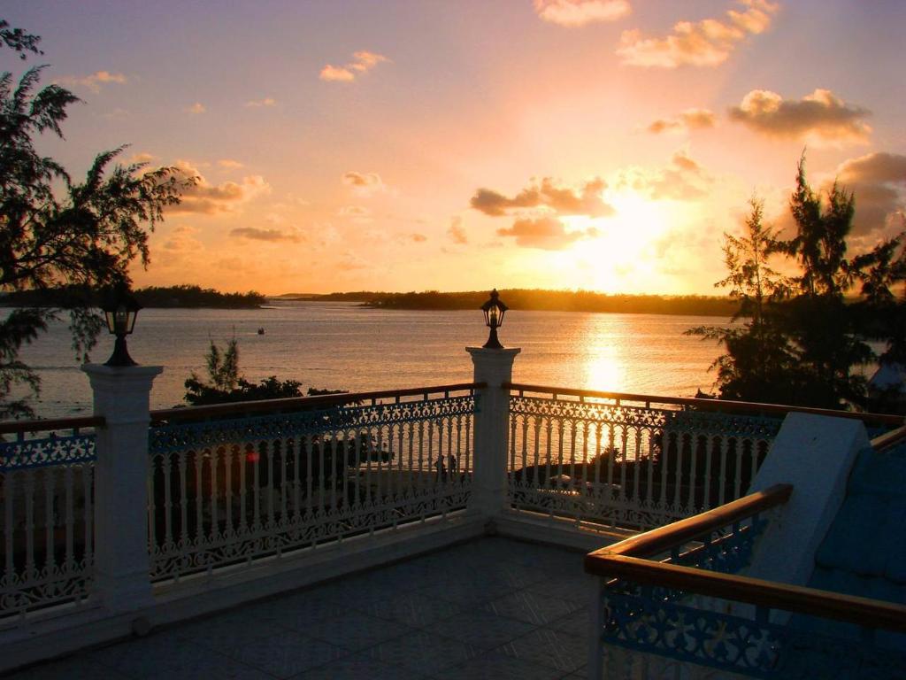 a view of a sunset from a balcony of a house at Villa Bella in Blue Bay