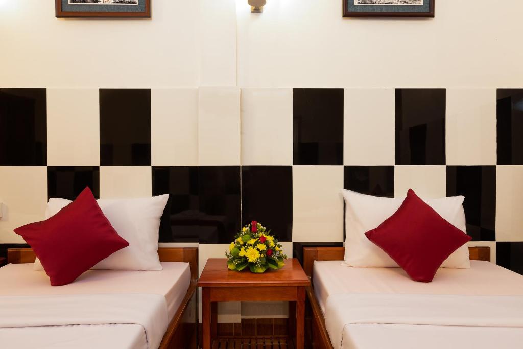 Ένα ή περισσότερα κρεβάτια σε δωμάτιο στο Botoum Hostel