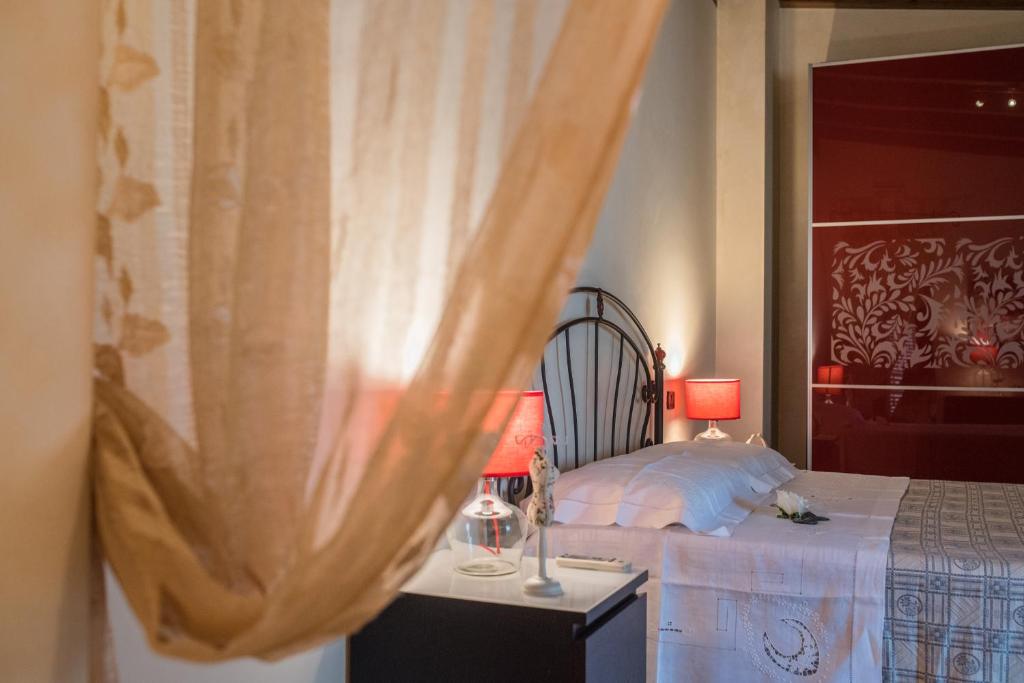 a bedroom with a bed and a table with two lamps at GioVì B&B Room in Terlizzi