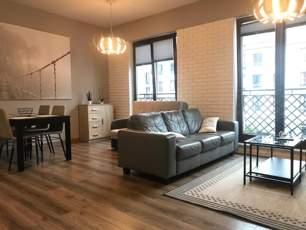 a living room with a couch and a table at VIP Apartamenty Białystok in Białystok