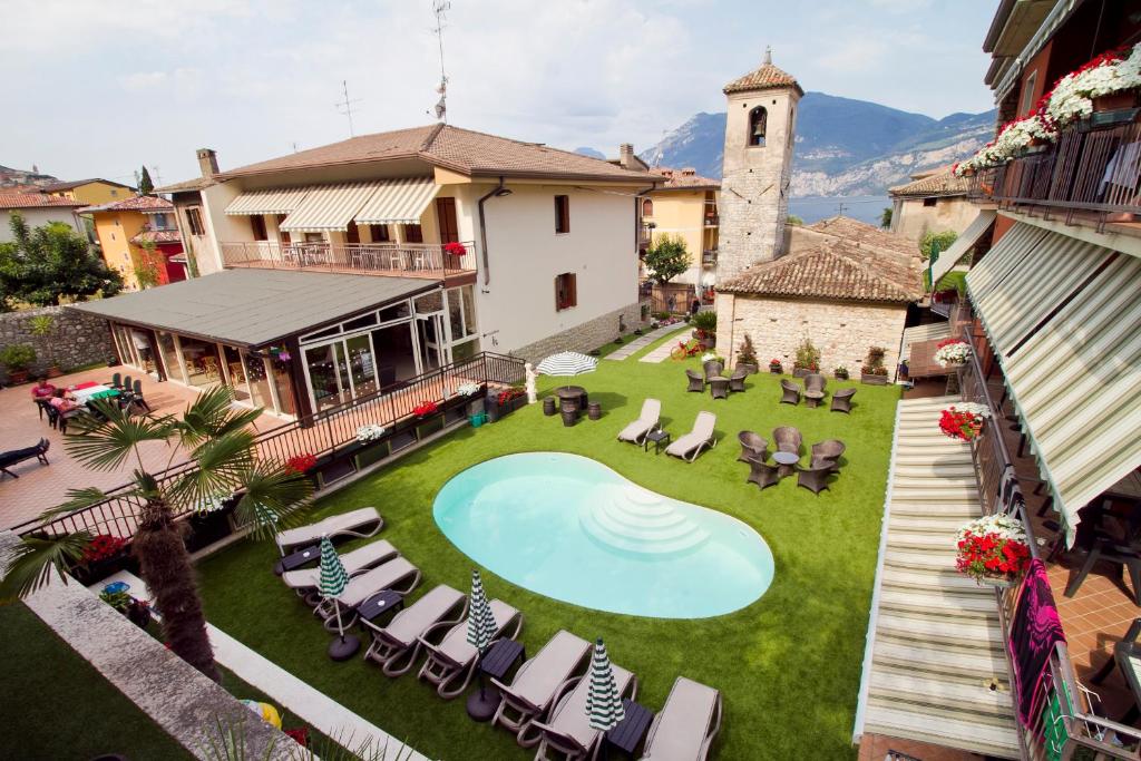 an overhead view of a yard with a swimming pool and chairs at Albergo Casa Este in Brenzone sul Garda