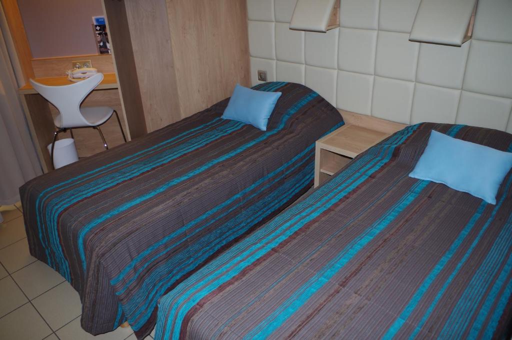 Postel nebo postele na pokoji v ubytování Hotel Espace Cite