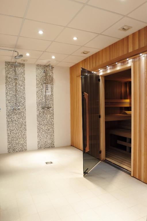 an empty room with a door in a room at Best Western Plus Hostellerie Du Vallon in Trouville-sur-Mer