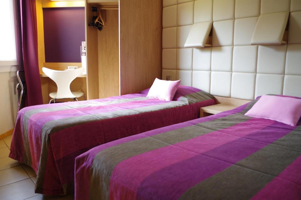 Postel nebo postele na pokoji v ubytování Hotel Espace Cite