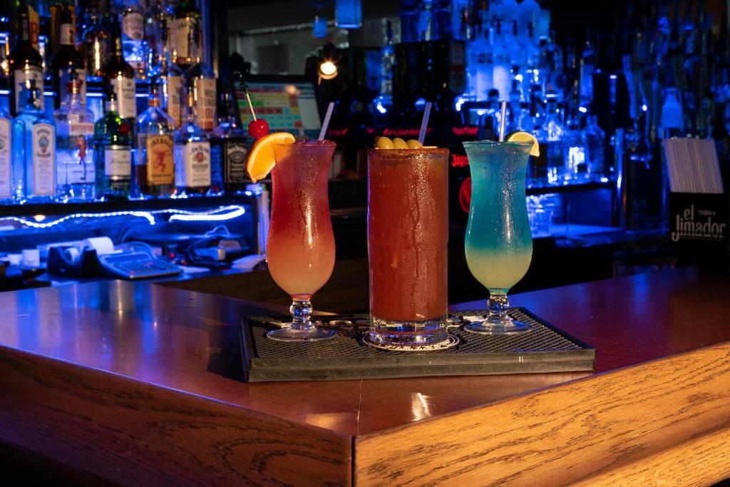 a group of three cocktails sitting on a bar at San Simeon Lodge in San Simeon