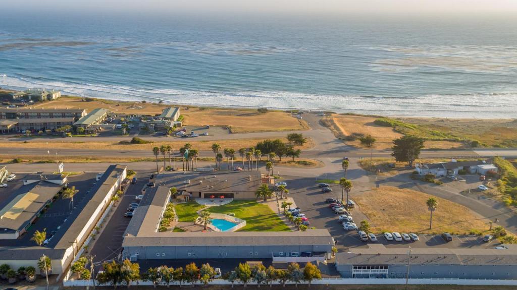 an aerial view of a parking lot next to the ocean at San Simeon Lodge in San Simeon