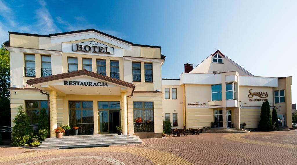 a hotel with a sign on the front of it at Hotel Santana in Białystok