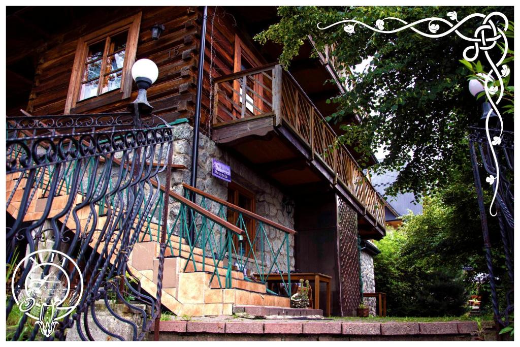 a building with a staircase and a balcony at Willa Alta in Bukowina Tatrzańska