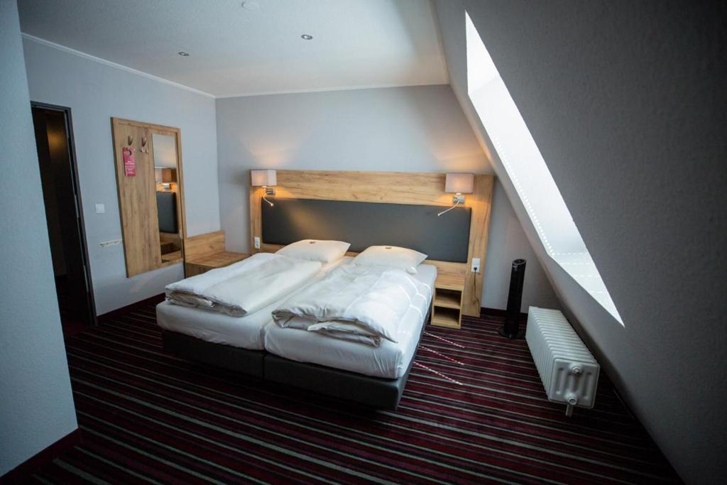 Postel nebo postele na pokoji v ubytování Hotel Süderelbe