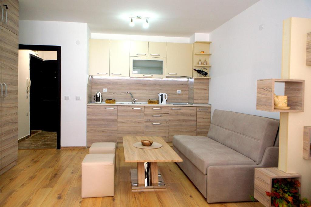 a living room with a couch and a table at Studio Top City Center in Sandanski