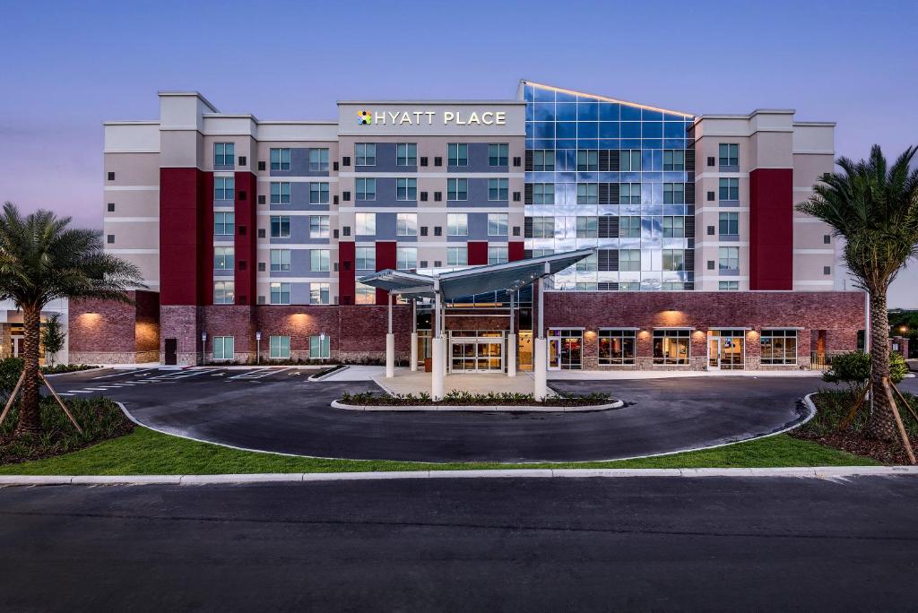 a hotel with a parking lot in front of a building at Hyatt Place Tampa/Wesley Chapel in Lutz