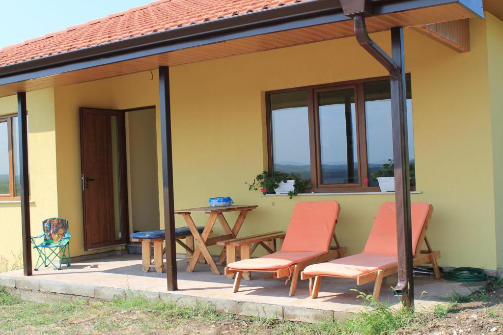 a patio with chairs and a table on a house at Malavi Guest House Krasen! Comfort&clean! in Krasen