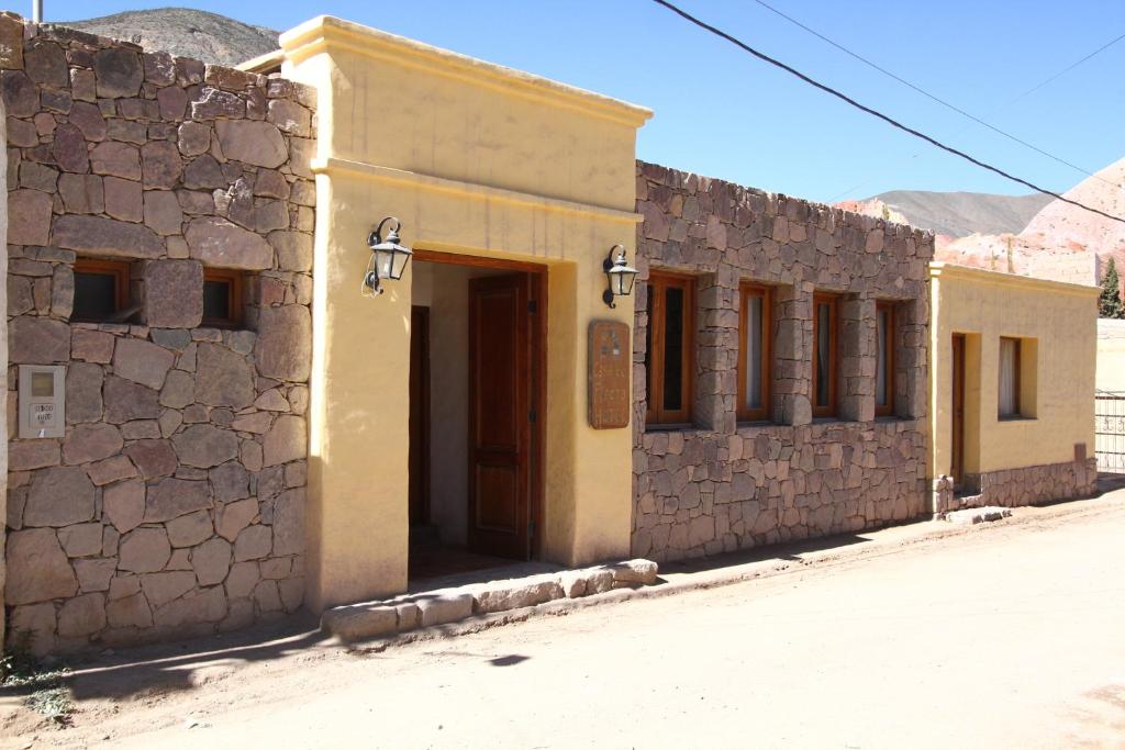 a building with a door in the middle of a street at Casa De Piedra in Purmamarca