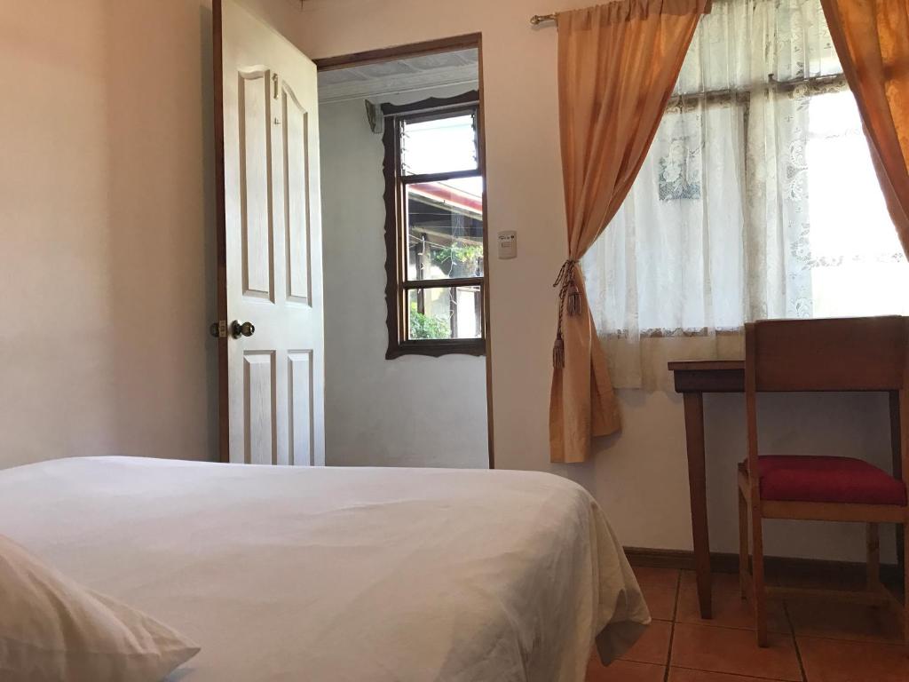 Postel nebo postele na pokoji v ubytování Casa Kibi Kibi
