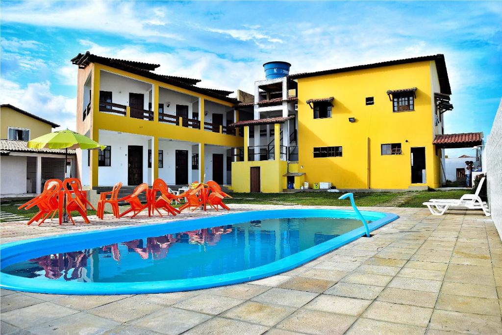 a swimming pool in front of a house at Pousada Solar Da Lagoa - Baixio BA in Baixio