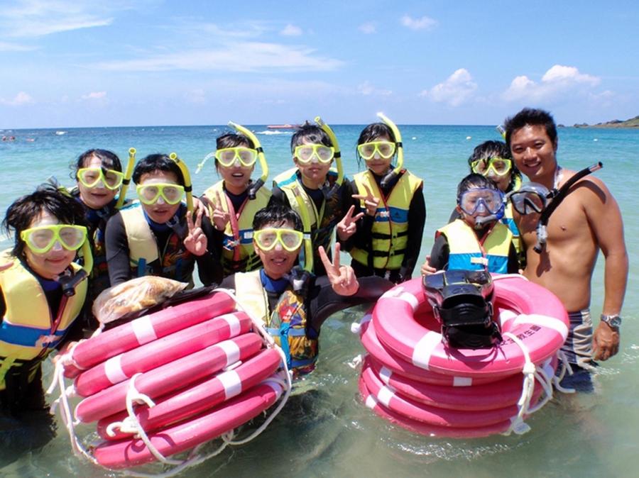 a group of people posing for a picture in the water at Caesar Park Hotel Kenting in Kenting