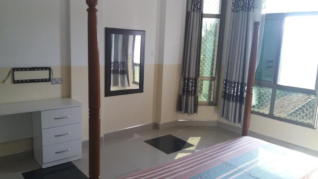 Postel nebo postele na pokoji v ubytování Ayodya Suites Nyali