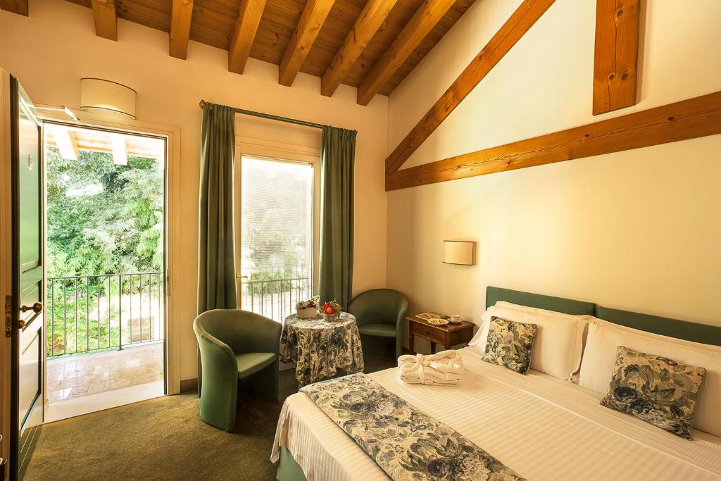 Postel nebo postele na pokoji v ubytování Albergo Al Moretto